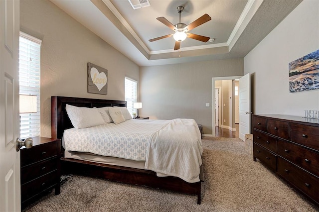 2473 Vellano Ln, Edmond, OK 73034 - bedroom featuring a tray ceiling, carpet flooring, ornamental molding, and ceiling fan