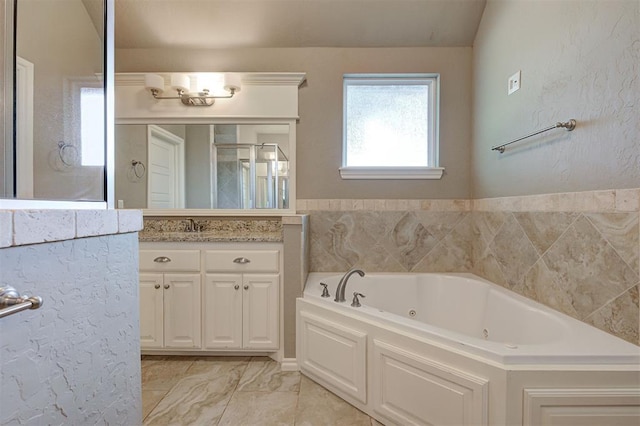 2473 Vellano Ln, Edmond, OK 73034 - bathroom with vanity, a jetted tub, a shower stall, and marble look tile flooring