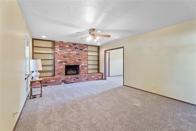 1317 Sue Ln, Choctaw, OK 73020 - unfurnished living room with a textured ceiling, carpet flooring, ceiling fan, a fireplace, and built in features