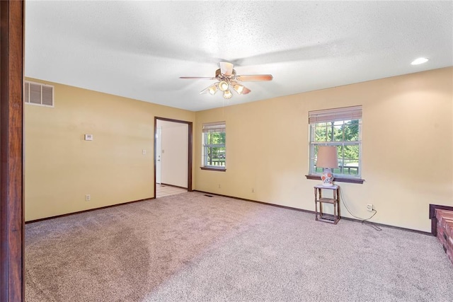 1317 Sue Ln, Choctaw, OK 73020 - empty room featuring ceiling fan, healthy amount of natural light, carpet flooring, and a textured ceiling