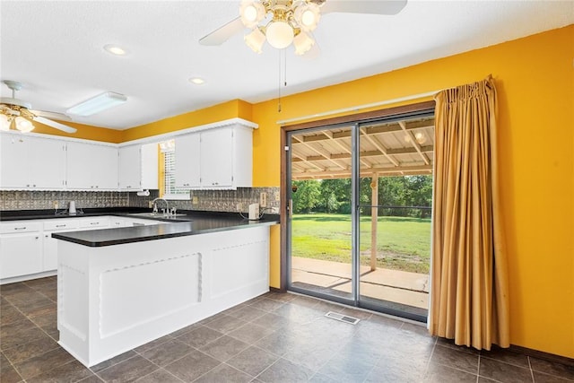 1317 Sue Ln, Choctaw, OK 73020 - kitchen with ceiling fan, dark countertops, a peninsula, plenty of natural light, and recessed lighting