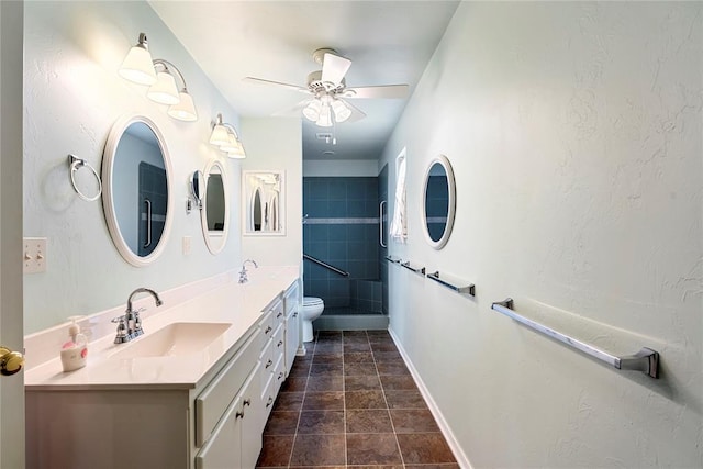1317 Sue Ln, Choctaw, OK 73020 - bathroom featuring double vanity, a ceiling fan, stone finish floors, and a shower