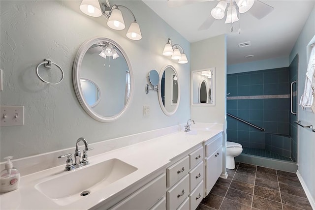 1317 Sue Ln, Choctaw, OK 73020 - bathroom with ceiling fan, double vanity, a shower stall, and stone finish flooring