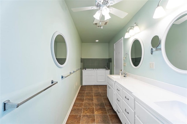 1317 Sue Ln, Choctaw, OK 73020 - full bathroom with double vanity, a ceiling fan, a garden tub, stone finish floors, and recessed lighting