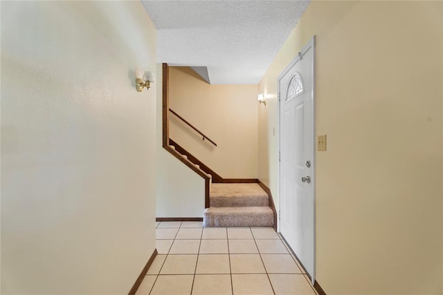 1317 Sue Ln, Choctaw, OK 73020 - foyer featuring stairway, light tile patterned floors, and a textured ceiling