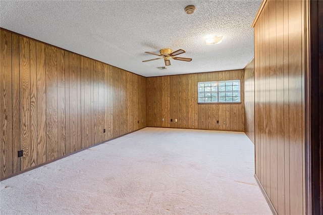 1317 Sue Ln, Choctaw, OK 73020 - unfurnished room with a ceiling fan, light colored carpet, a smoke detector, a textured ceiling, and wooden walls