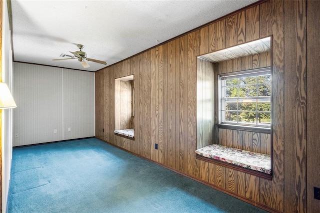 1317 Sue Ln, Choctaw, OK 73020 - carpeted empty room featuring a ceiling fan, wooden walls, and a textured ceiling