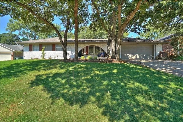 1013 Mary Lee Ln, Edmond, OK 73034 - ranch-style home with a garage, concrete driveway, a front lawn, and brick siding