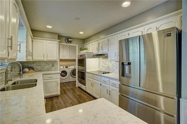 1013 Mary Lee Ln, Edmond, OK 73034 - kitchen featuring stainless steel appliances, washing machine and clothes dryer, white cabinets, backsplash, and recessed lighting