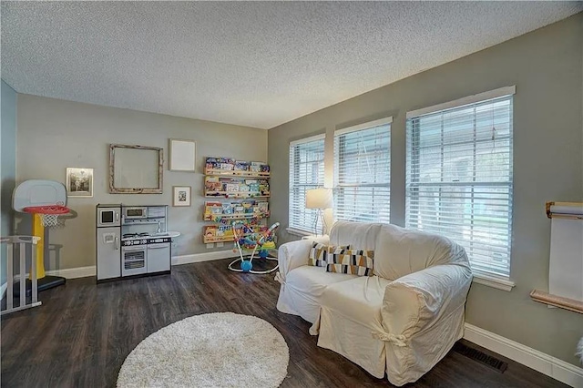 1013 Mary Lee Ln, Edmond, OK 73034 - living area with a textured ceiling and wood finished floors