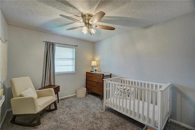 1013 Mary Lee Ln, Edmond, OK 73034 - bedroom featuring carpet flooring, a nursery area, ceiling fan, and a textured ceiling