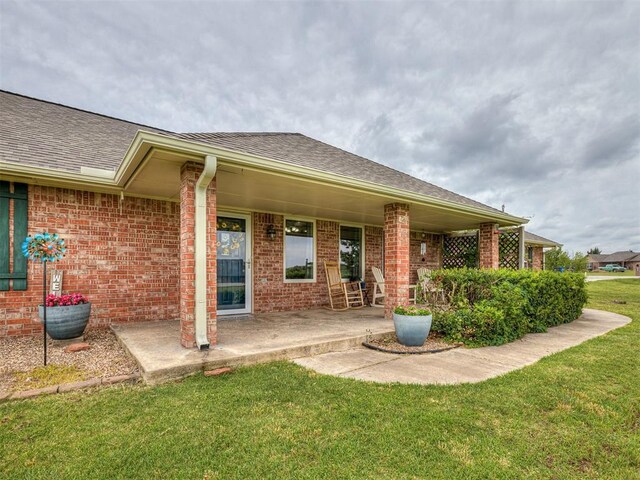 975 Garden Rd, Tuttle, OK 73089 - rear view of property featuring a yard, brick siding, and roof with shingles