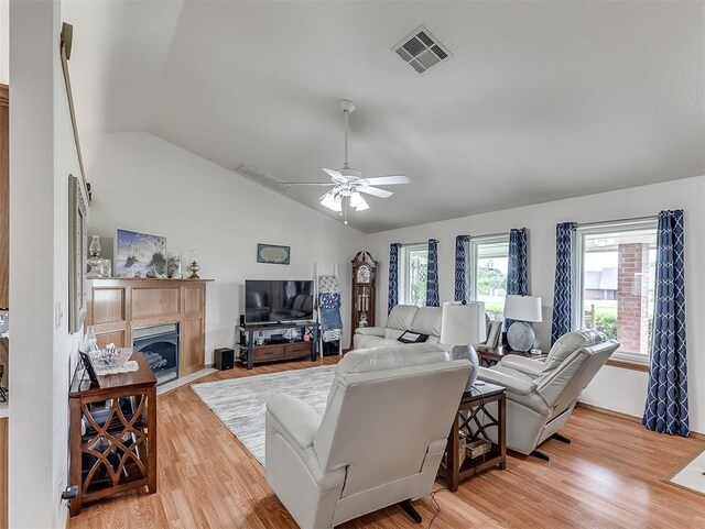 975 Garden Rd, Tuttle, OK 73089 - living area with vaulted ceiling, ceiling fan, light wood-type flooring, and a tile fireplace