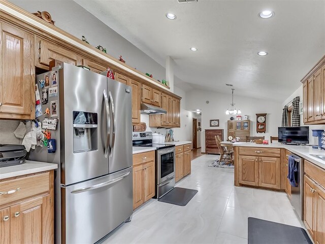 975 Garden Rd, Tuttle, OK 73089 - kitchen featuring appliances with stainless steel finishes, vaulted ceiling, light countertops, a peninsula, and recessed lighting