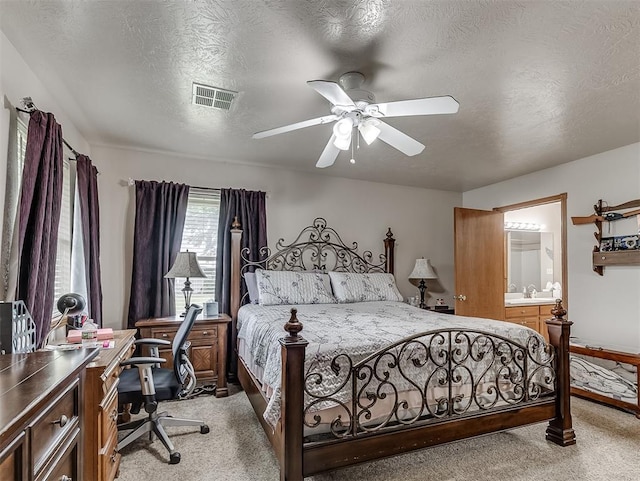 975 Garden Rd, Tuttle, OK 73089 - bedroom featuring light colored carpet, a desk, a textured ceiling, ensuite bath, and ceiling fan
