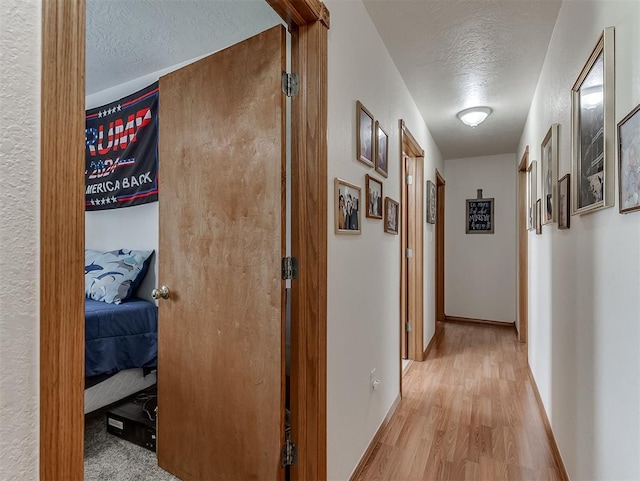 975 Garden Rd, Tuttle, OK 73089 - corridor featuring a textured ceiling and wood finished floors