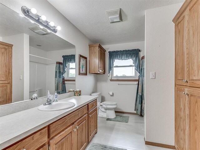 975 Garden Rd, Tuttle, OK 73089 - bathroom with vanity, a shower with shower curtain, tile patterned floors, and a textured ceiling