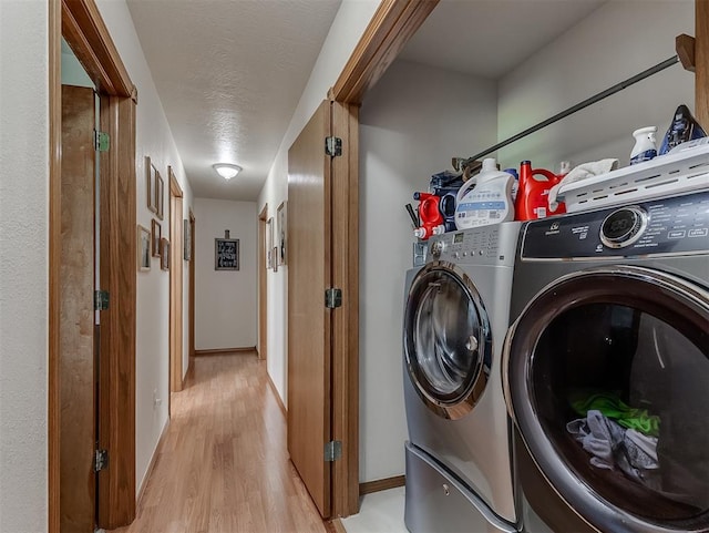 975 Garden Rd, Tuttle, OK 73089 - laundry room with light wood-style flooring, washer and dryer, and a textured ceiling