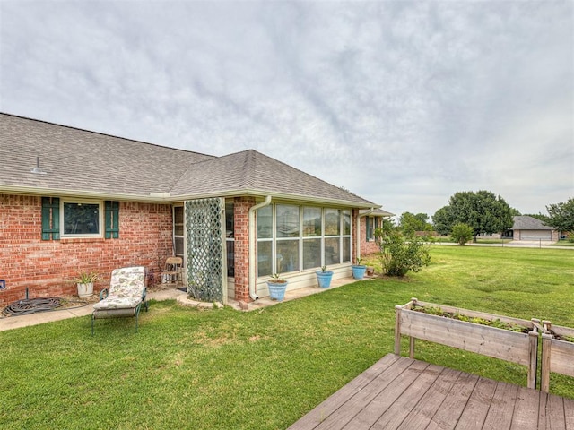 975 Garden Rd, Tuttle, OK 73089 - view of grassy yard featuring a wooden deck and a sunroom