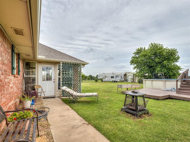 975 Garden Rd, Tuttle, OK 73089 - view of green lawn with a deck and a fire pit