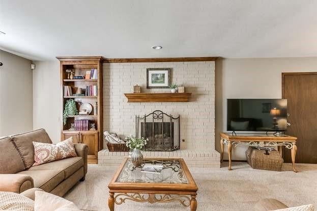 801 Belle Air Ave, Edmond, OK 73013 - carpeted living area featuring a fireplace