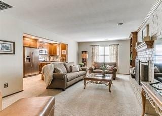 801 Belle Air Ave, Edmond, OK 73013 - living room with healthy amount of natural light, light colored carpet, and a fireplace with raised hearth