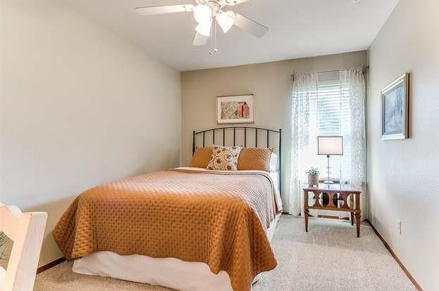 801 Belle Air Ave, Edmond, OK 73013 - bedroom with light colored carpet and ceiling fan