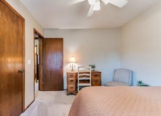 801 Belle Air Ave, Edmond, OK 73013 - bedroom with carpet flooring and a ceiling fan