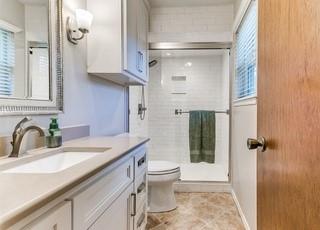 801 Belle Air Ave, Edmond, OK 73013 - bathroom featuring vanity, a shower stall, and healthy amount of natural light