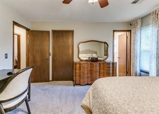 801 Belle Air Ave, Edmond, OK 73013 - bedroom featuring carpet, two closets, and a ceiling fan
