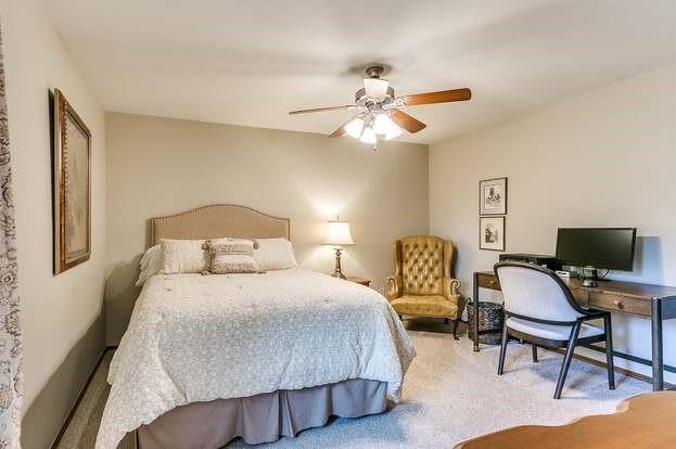 801 Belle Air Ave, Edmond, OK 73013 - carpeted bedroom with a ceiling fan and an office area