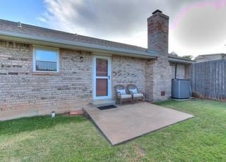 801 Belle Air Ave, Edmond, OK 73013 - rear view of house featuring a chimney and a patio area
