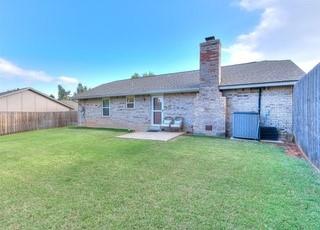 801 Belle Air Ave, Edmond, OK 73013 - rear view of house featuring a chimney, a fenced backyard, and a patio area