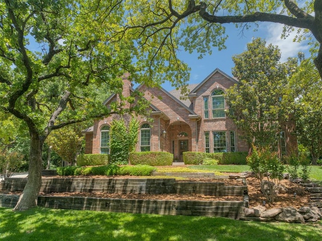 1300 Oak Springs Ln, Edmond, OK 73034 - traditional home featuring brick siding and a front yard