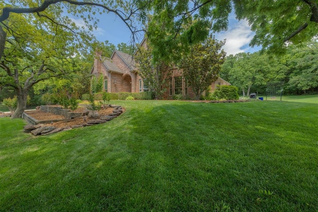1300 Oak Springs Ln, Edmond, OK 73034 - view of grassy yard with a vegetable garden
