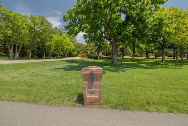 1300 Oak Springs Ln, Edmond, OK 73034 - view of community featuring a lawn and view of wooded area