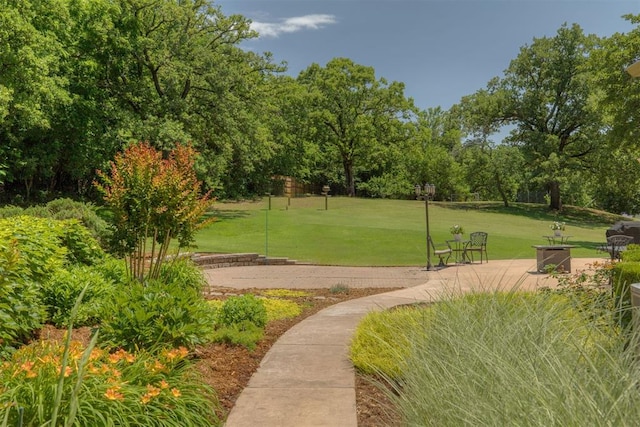 1300 Oak Springs Ln, Edmond, OK 73034 - view of property's community with a lawn and view of wooded area