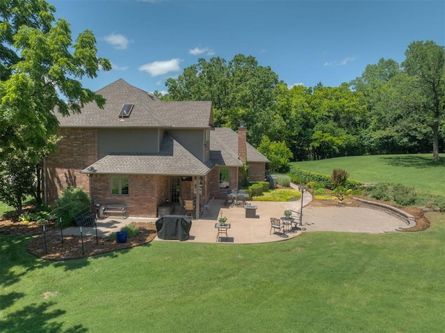 1300 Oak Springs Ln, Edmond, OK 73034 - back of house with a chimney, a yard, a patio, a shingled roof, and brick siding