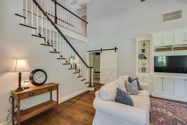 1300 Oak Springs Ln, Edmond, OK 73034 - living room with a barn door, dark wood-style flooring, stairway, and a high ceiling