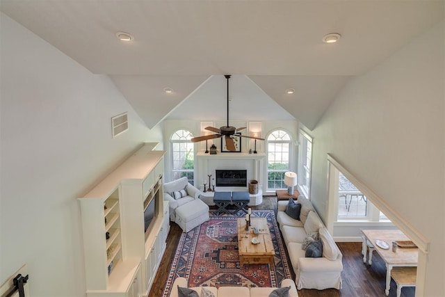 1300 Oak Springs Ln, Edmond, OK 73034 - living room with dark wood-type flooring, healthy amount of natural light, a glass covered fireplace, ceiling fan, and recessed lighting