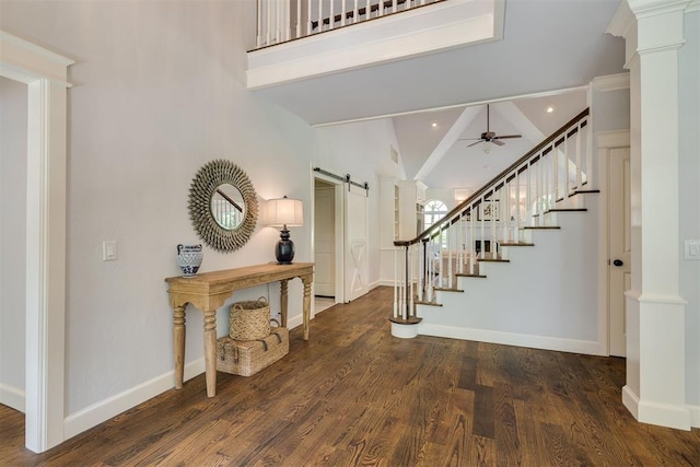 1300 Oak Springs Ln, Edmond, OK 73034 - foyer with a barn door, stairs, ceiling fan, wood finished floors, and beam ceiling