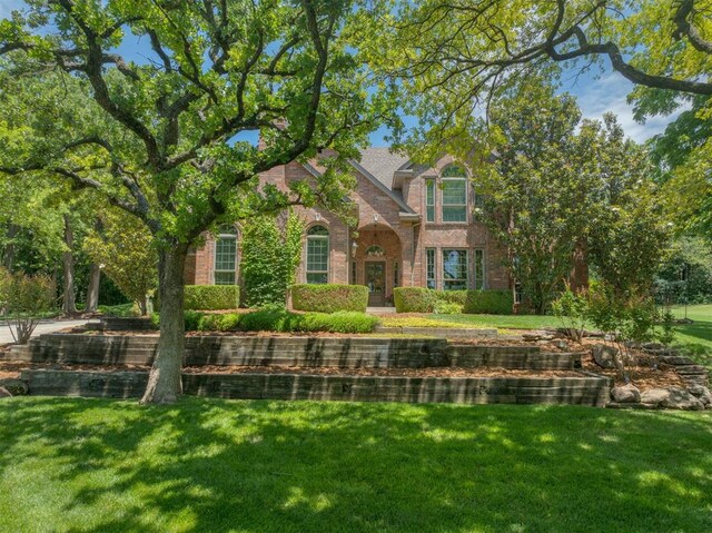 1300 Oak Springs Ln, Edmond, OK 73034 - view of front of house featuring brick siding and a front lawn