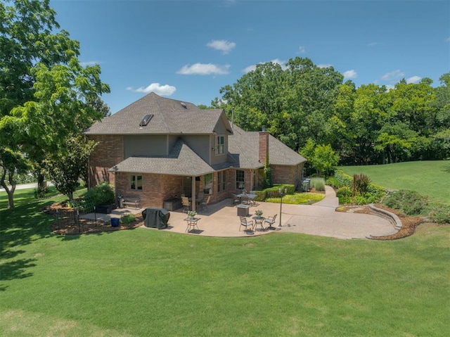 1300 Oak Springs Ln, Edmond, OK 73034 - rear view of property featuring a chimney, a lawn, a patio, and brick siding