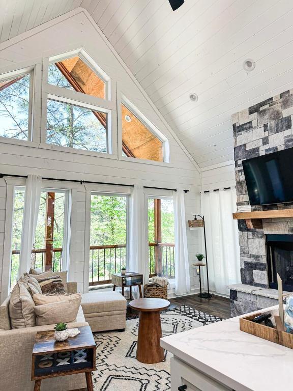 142 Champion Way, Broken Bow, OK 74728 - living room with plenty of natural light, a fireplace, light wood-style floors, high vaulted ceiling, and wooden ceiling