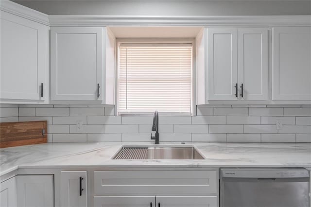 kitchen featuring stainless steel dishwasher, white cabinetry, decorative backsplash, and light stone countertops