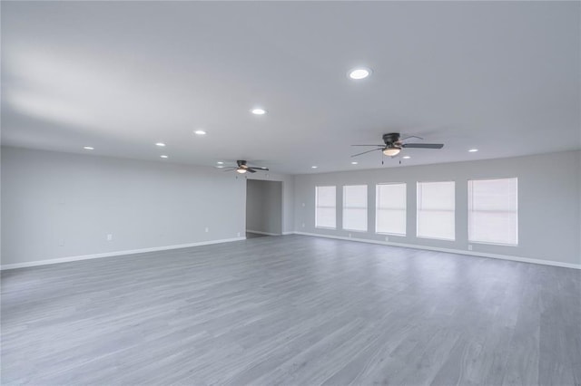 unfurnished room featuring a ceiling fan, recessed lighting, and wood finished floors