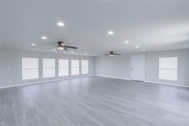 unfurnished living room featuring ceiling fan, recessed lighting, and wood finished floors