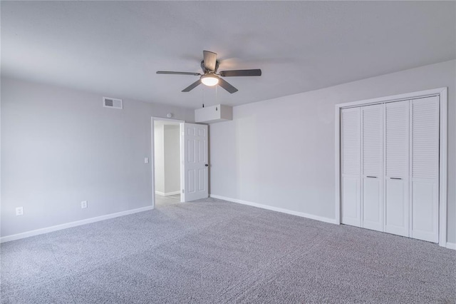 unfurnished bedroom featuring carpet flooring, a closet, and a ceiling fan