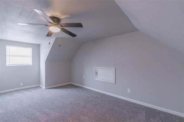 bonus room with lofted ceiling, carpet flooring, and ceiling fan