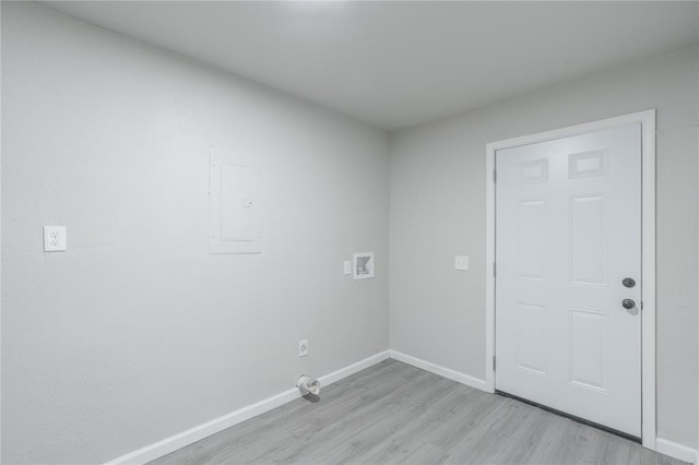 washroom featuring electric panel, light wood-type flooring, and washer hookup